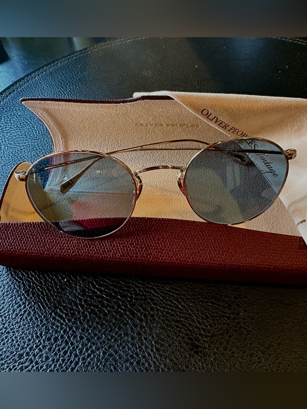 Oliver Peoples Gold Frame Sunglasses with blue Lenses